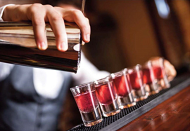 a bartender pouring shots of alcohol